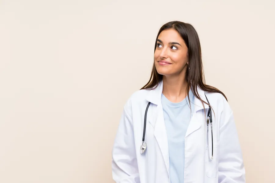 A woman wearing a white coat