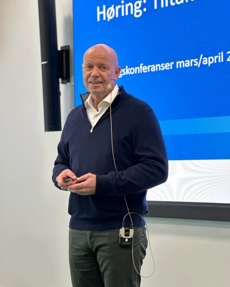 En person som står foran et skilt